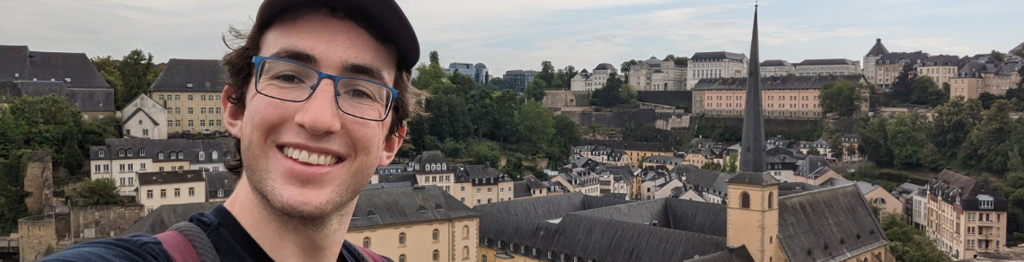 Student standing in front of a city in Germany from a high viewpoint