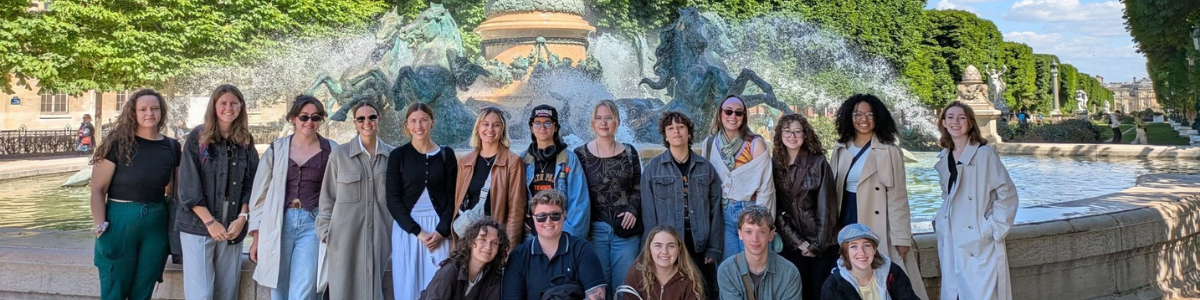 Group photo of students who participated in the France Field School last year posing in front of a fountain