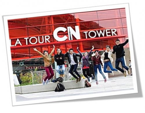 Photo of students jumping outside the CN tower sign