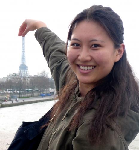 Image of student touching the top of the Eiffel tower 